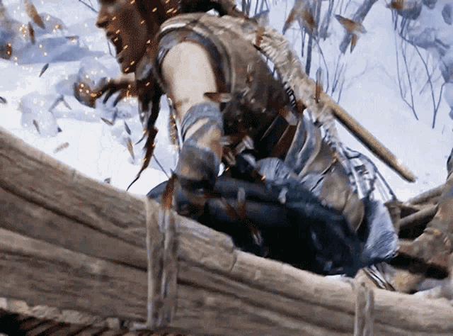 a man with a sword is kneeling on a wooden bridge in the snow