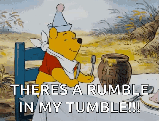 winnie the pooh sitting at a table with a jar of honey