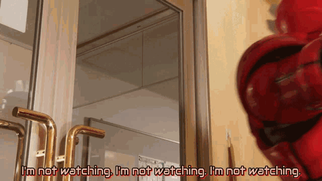 a man in a red suit says i 'm not watching i 'm not watching
