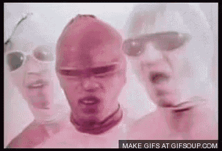 a group of men are standing next to each other wearing pink masks and sunglasses .