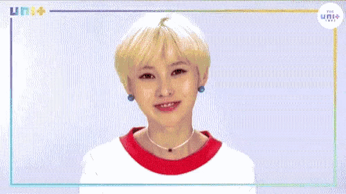 a woman with short blonde hair is eating a piece of cake .