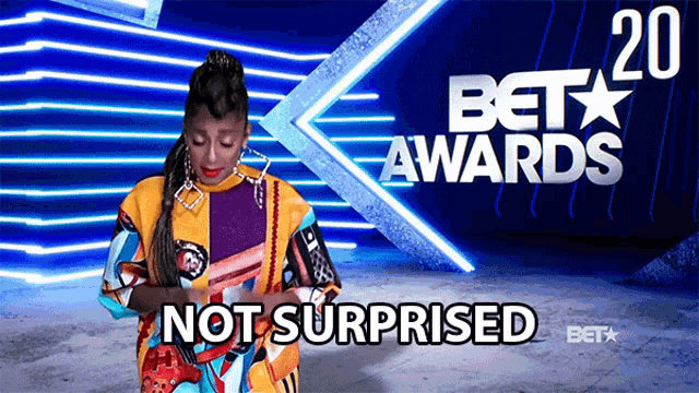 a woman is surprised in front of a bet awards banner