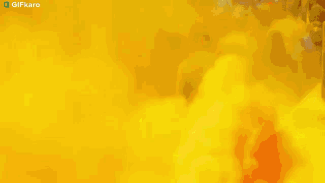 a drone is flying in the air with a yellow background behind it .