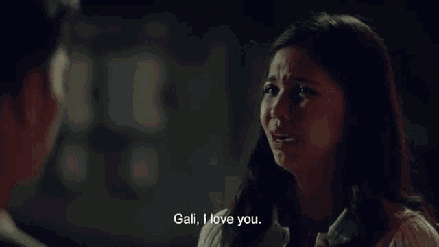 a man and a woman are looking at each other and the woman is crying and saying `` gali , i love you '' .