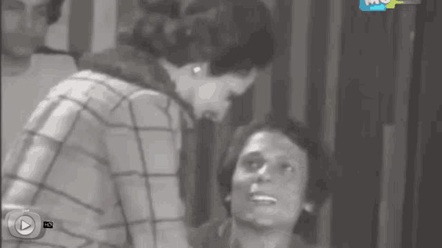 a black and white photo of a man and a woman with a play button on the bottom right