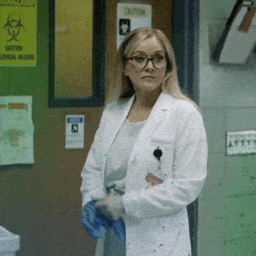 a woman in a lab coat stands in front of a sign that says caution logical hazard
