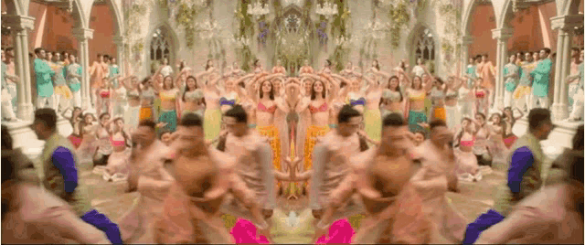 a group of people are dancing together in a room