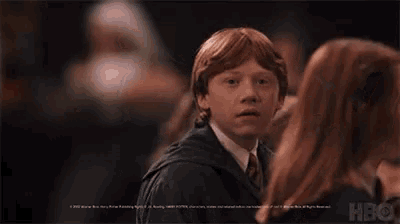 a harry potter character is smiling in front of a hbo logo
