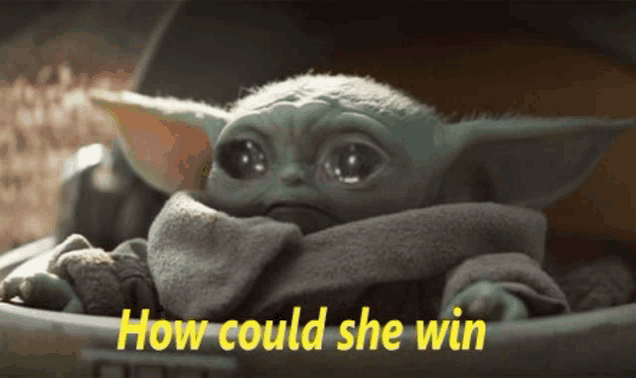 a baby yoda from star wars is sitting in a bucket with the words `` how could she win '' .