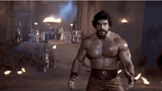 a very muscular man with a beard is standing in front of a group of people holding a sword .