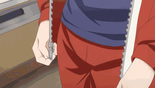 a person in red pants is holding a piece of paper in their hand