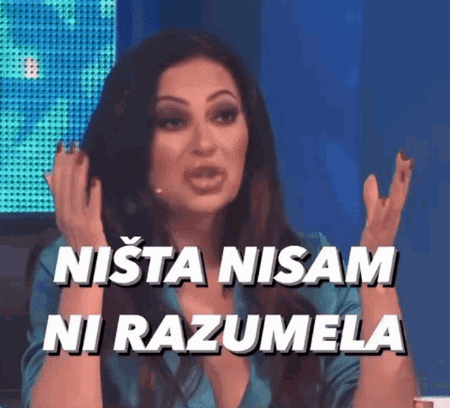a woman in a blue shirt is making a funny face with the words nista nisam ni razumela behind her .