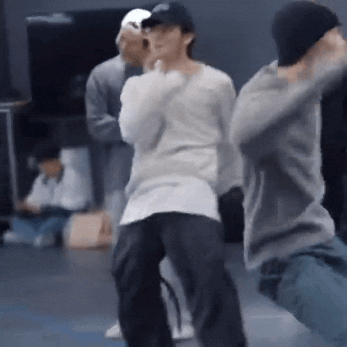 a group of people are dancing in a room .