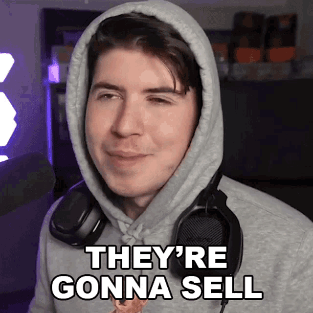 a man wearing headphones and a hooded sweatshirt says they 're gonna sell