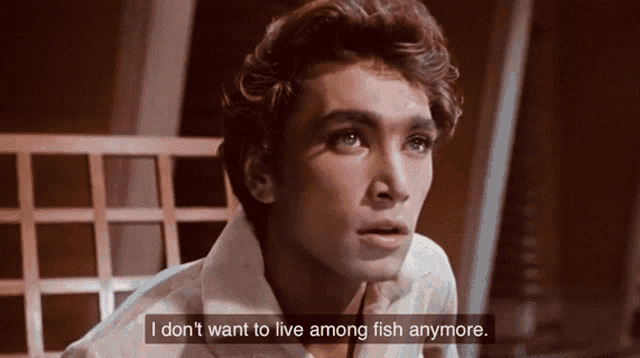 a man in a white shirt says i don t want to live among fish anymore