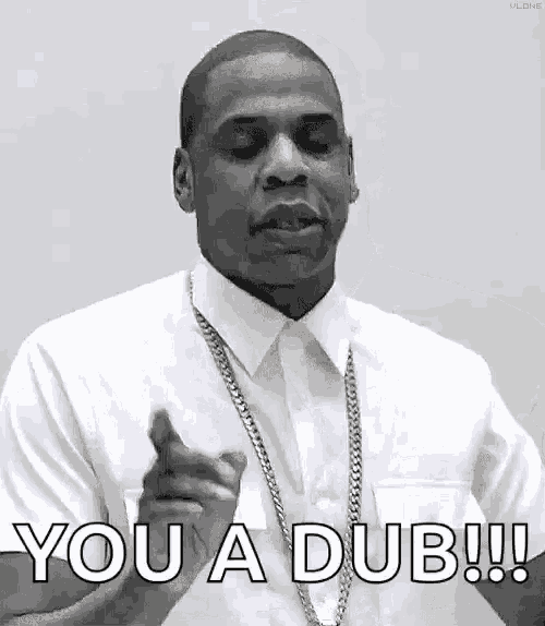 a man in a white shirt and tie is pointing at the camera and saying `` you a dub '' .