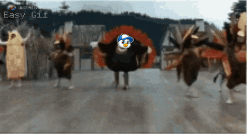 a group of turkeys are dancing in front of a building with the words easy gif below them