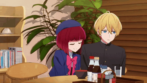a boy and a girl sit at a table with bottles of sauce