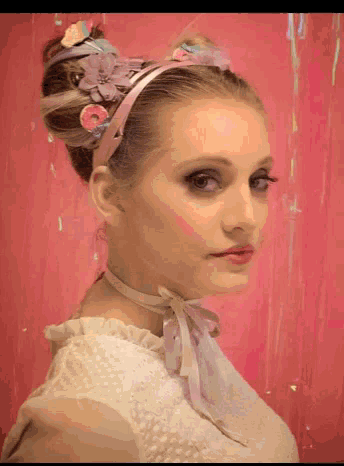 a woman wearing a headband with flowers and candy in her hair