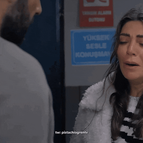a woman is crying in front of a man and the words tw : pistachiogrentv can be seen below her