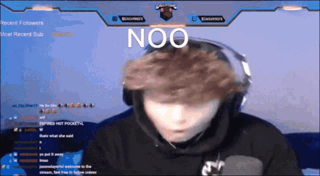 a man wearing headphones says noo in front of a blue screen