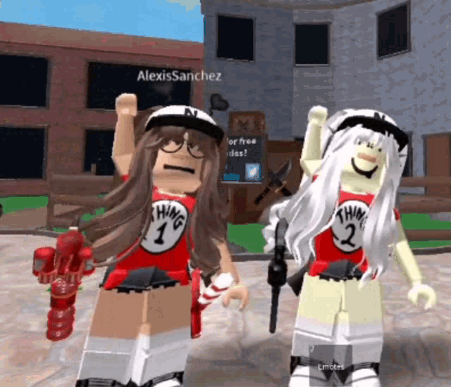 two girls wearing thing 1 and thing 2 shirts are standing next to each other in front of a building