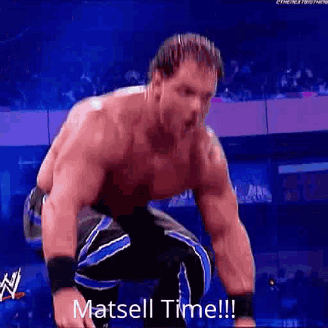 a man is kneeling down in a wrestling ring with the words `` matsell time '' written on the bottom .