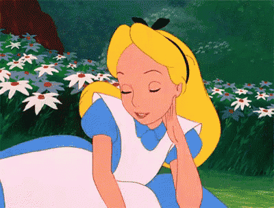 alice from alice in wonderland is sitting in a field of flowers with her eyes closed