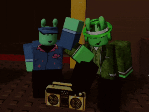 two green characters standing next to a boombox