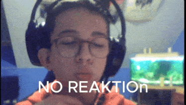 a boy wearing headphones and glasses has the word no reaktion written on his face