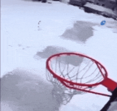 a basketball hoop in the snow with a drawing of a person behind it