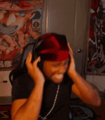 a man wearing headphones and a red headband has the letter o on his head