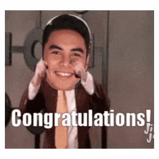 a man in a suit and tie is smiling and saying congratulations