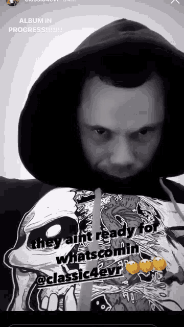 a black and white photo of a man wearing a hoodie with the words album in progress