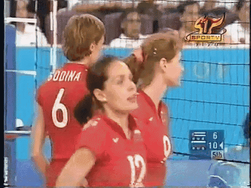 two female volleyball players with the number 6 and 12 on their shirts