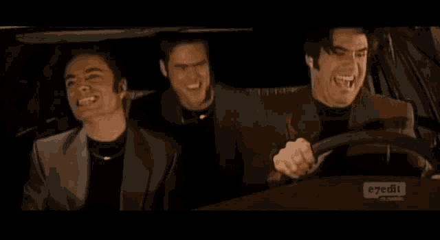 three men are sitting in a car with e7edit written on the bottom right