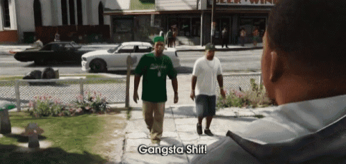 two men walking down a sidewalk with the words gangsta shit on the bottom