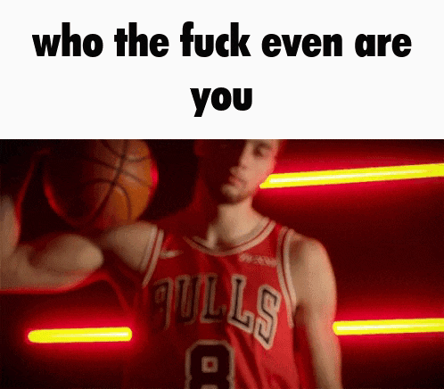 a basketball player in a bulls uniform is holding a basketball in his hand .