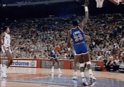 a basketball player with the number 33 on his jersey is jumping in the air