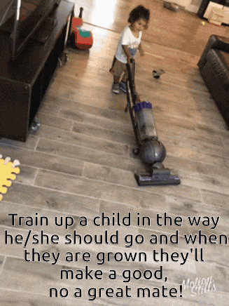 a young boy is using a vacuum cleaner to clean the floor