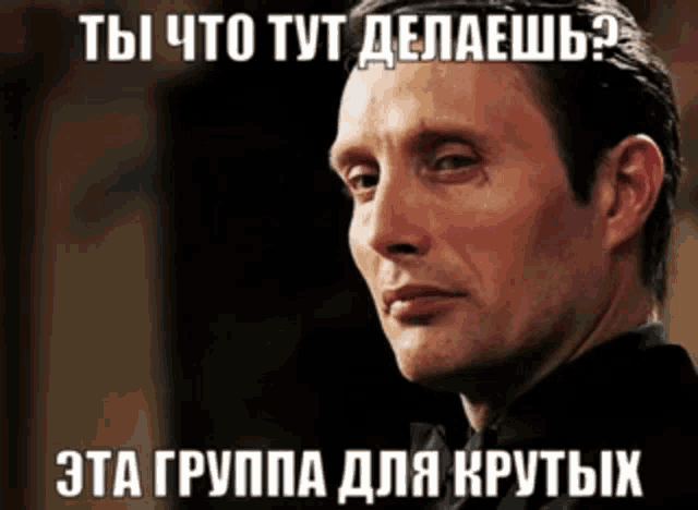 a man in a black shirt with a caption in a foreign language