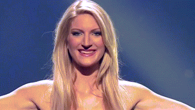 a woman with long blonde hair is smiling in front of a dark blue background