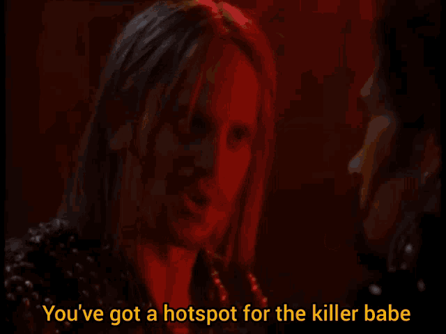 a man with long hair is talking to another man with the words you 've got a hotspot for the killer babe