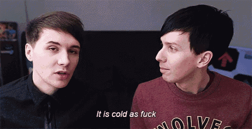 two men are talking to each other and one of them is wearing a sweater that says wolves