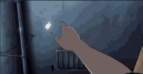 a person 's hand is pointing at a butterfly that is flying in the air