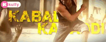 a man in a black tank top stands in front of the word kabai