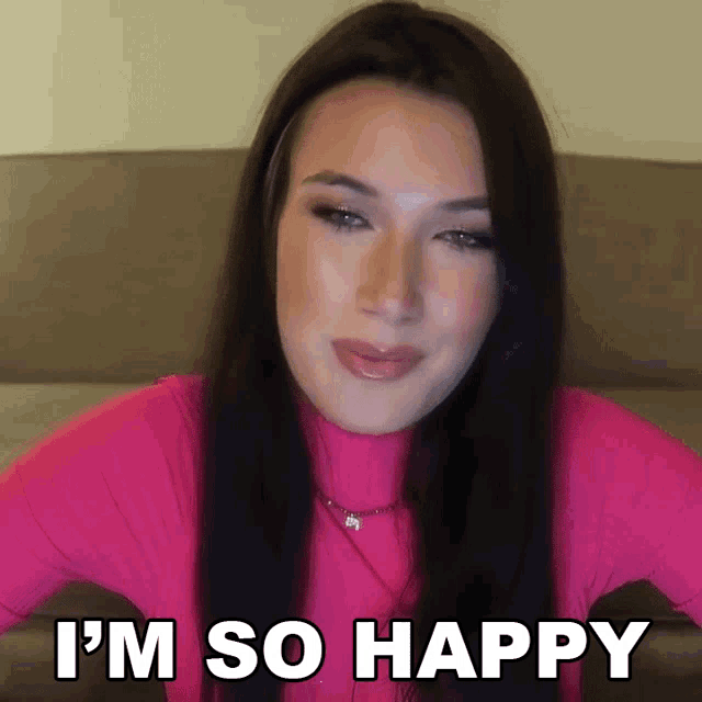 a woman says i 'm so happy in a pink shirt