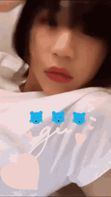 a girl wearing a white shirt with three blue bears and the word girl