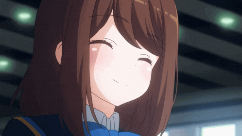 a close up of a girl 's face with a smile on her face