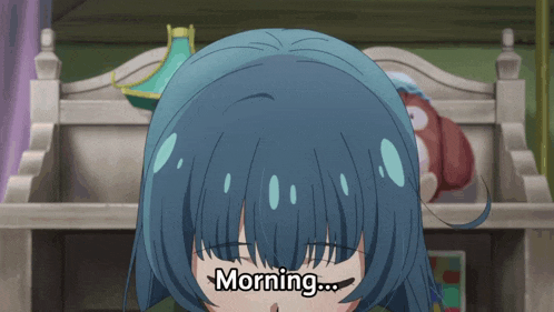 a girl with blue hair says morning in front of a bed